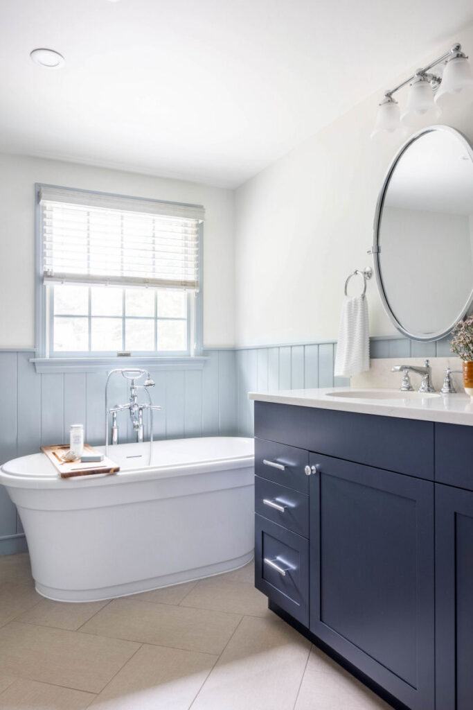 Stoneham bathroom design remodel with blue vanity and soaking tub