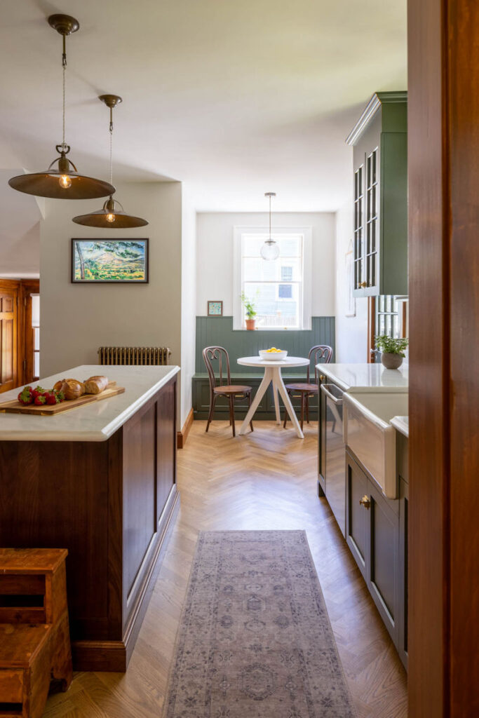 Melrose Kitchen Design with olive green cabinets and a walnut island and breakfast nook