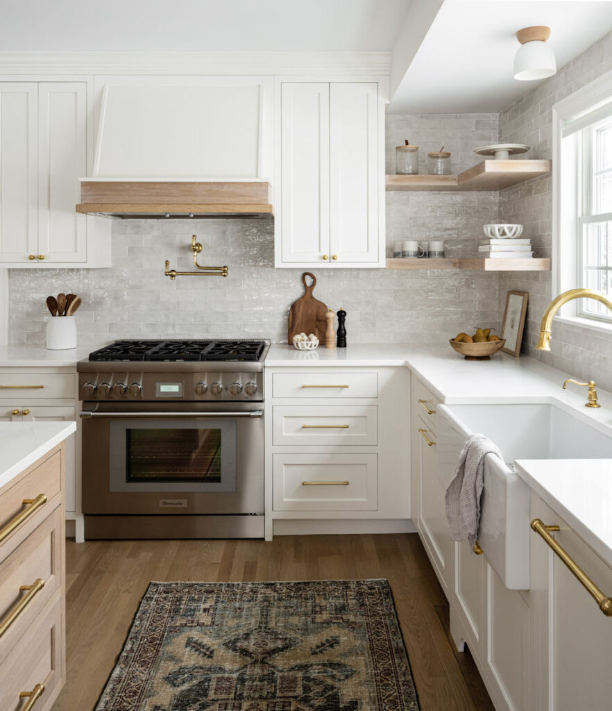 Winchester Kitchen Design with white kitchen cabinets and gold hardware - McGuire + Co. Kitchen & Bath