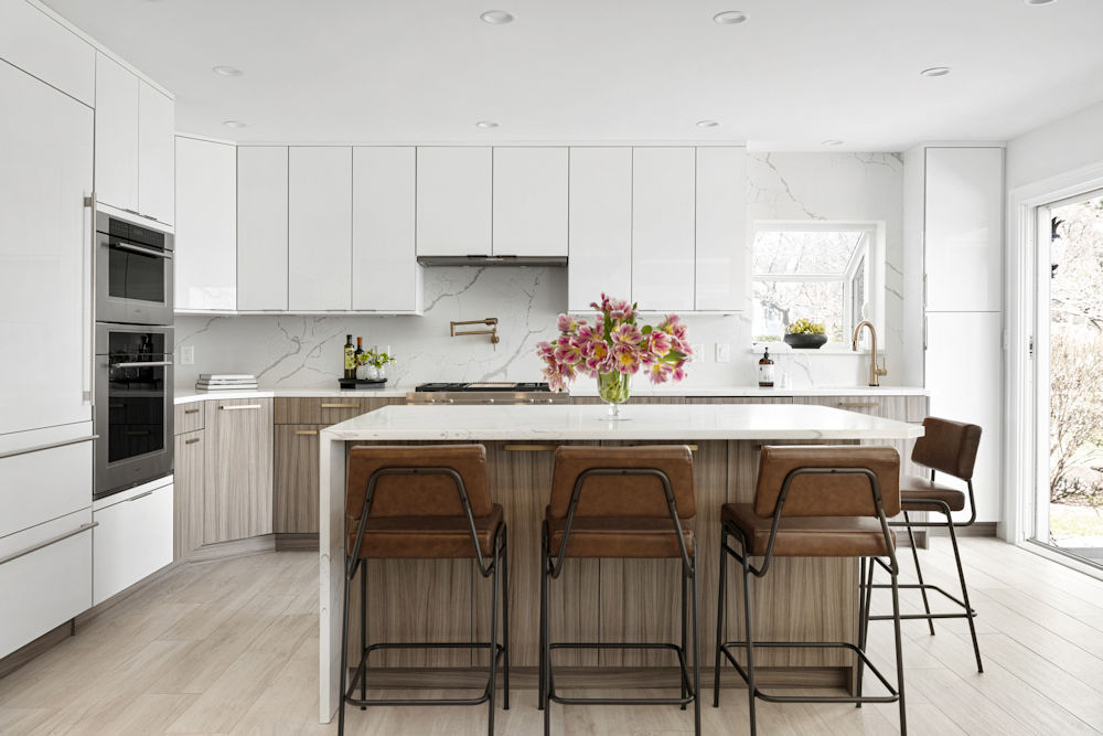 Contemporary kitchen in Lynnfield MA with high gloss white upper cabinets and an island with a thermostructured surface.