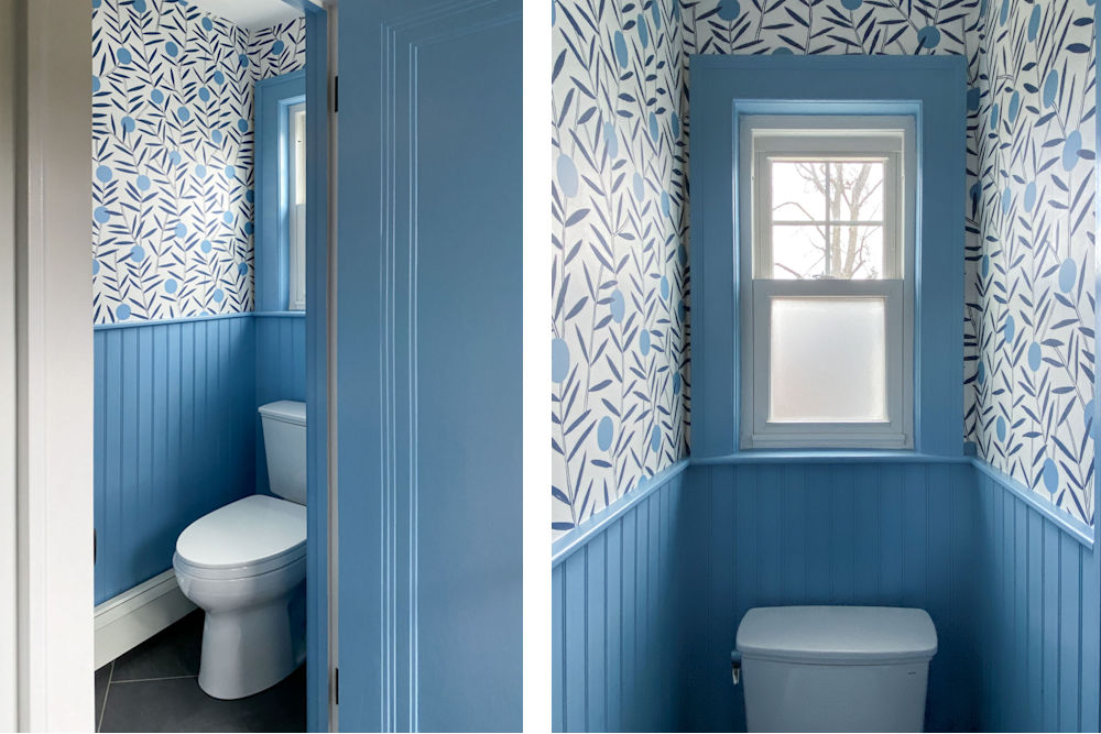 Vintage powder room with bold wallpaper and beadboard walls halfway up painted cornflower blue.