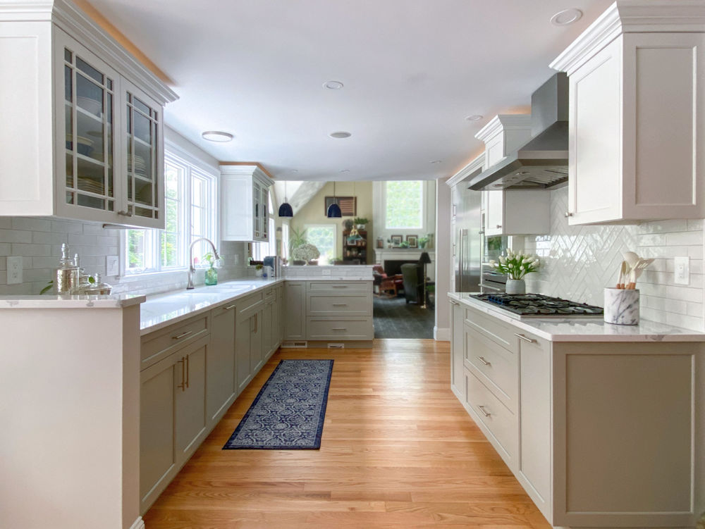 Kitchen remodel in Andover with white and gray cabinets, quartz countertops, and white tile backsplash
