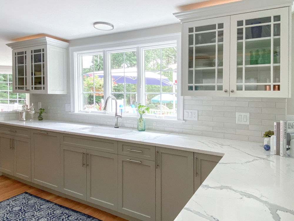 Kitchen remodel in Andover with white and gray cabinets, quartz countertops, and white tile backsplash