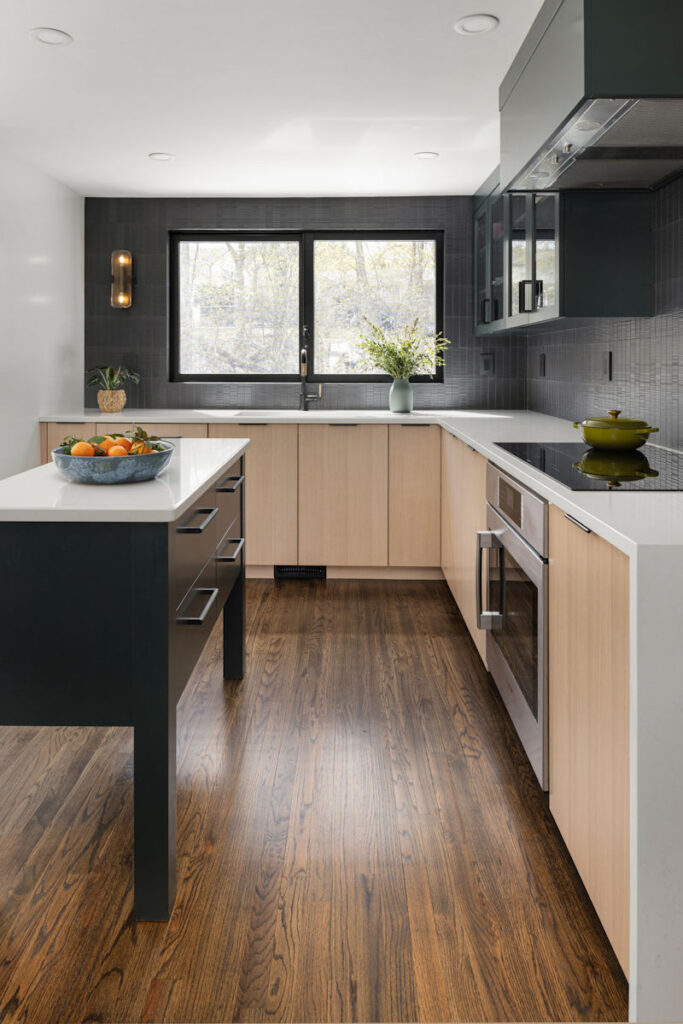 Modern Cape Kitchen Design and Remodel with black tile backsplash, rift-sawn white oak and hunter green cabinetry, a kitchen island, and quartz countertops