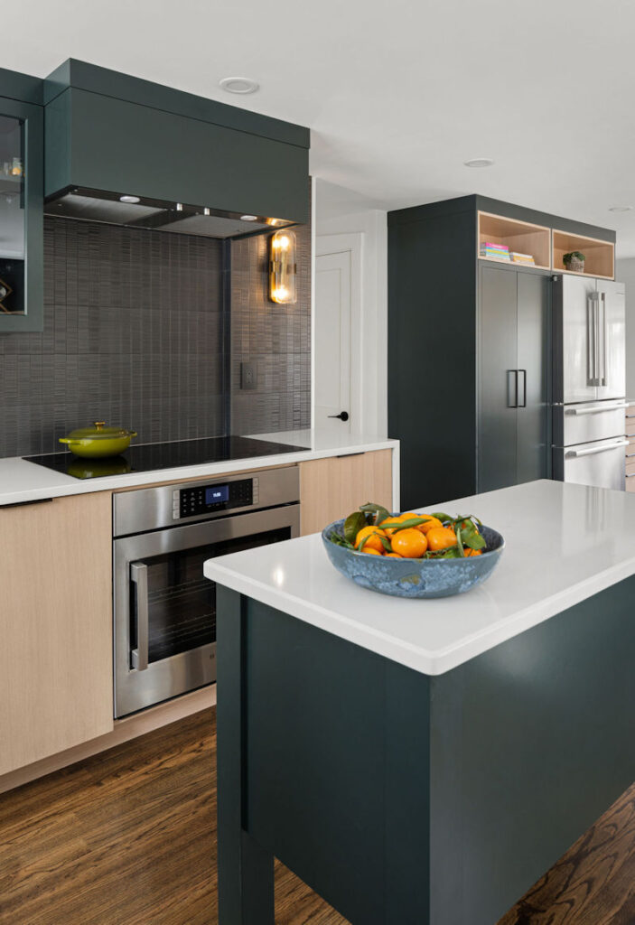 Modern Cape Kitchen with black tile backsplash, rift-sawn white oak and hunter green cabinetry, green kitchen island, and quartz countertops