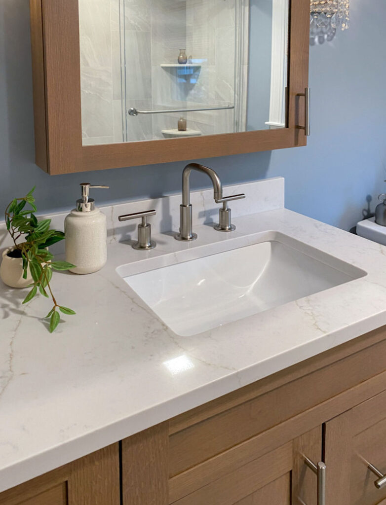 Stoneham home remodeling project bathroom design and remodel with white oak vanity and medicine cabinet, quartz countertop, and soft brushed fixtures and hardware
