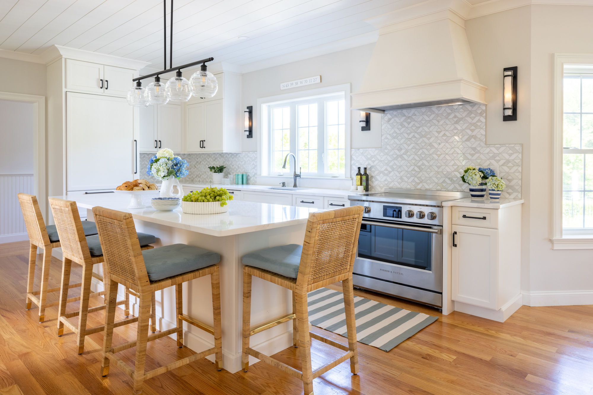 North Reading kitchen design and remodel with white cabinetry and shiplap ceiling - McGuire + Co. Kitchen & Bath