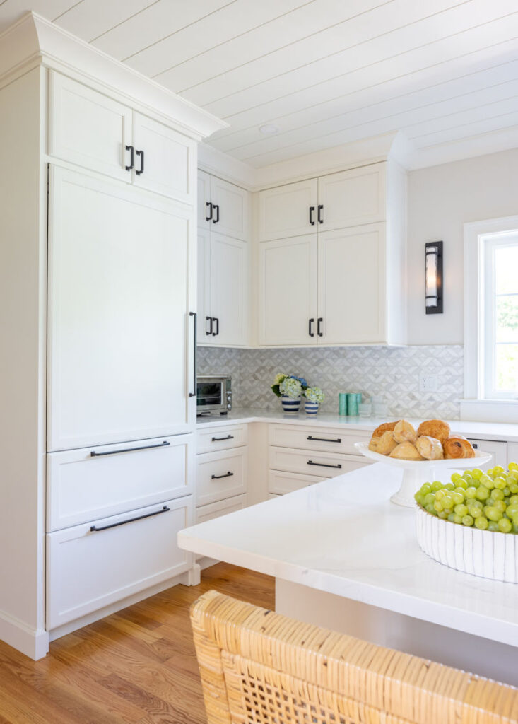 North Reading kitchen design and remodel with white cabinetry and shiplap ceiling - McGuire + Co. Kitchen & Bath