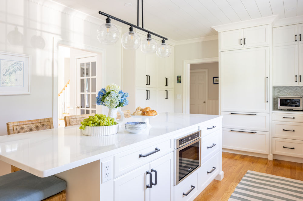 North Reading kitchen design and remodel with white cabinetry and large kitchen island - McGuire + Co. Kitchen & Bath