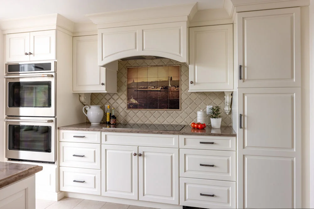 Kitchen design-build remodel in Stoneham MA with double oven and sleek cooktop and custom tile backsplash