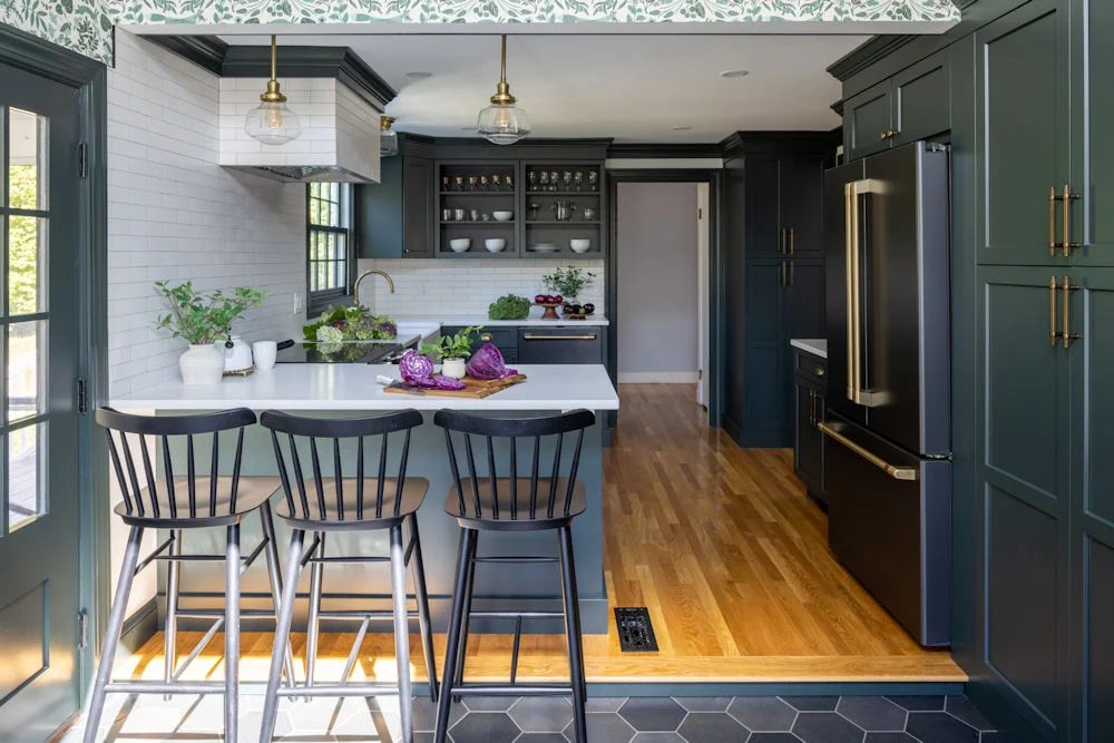 Wakefield kitchen remodel with green cabinetry and white textured subway tile backsplash