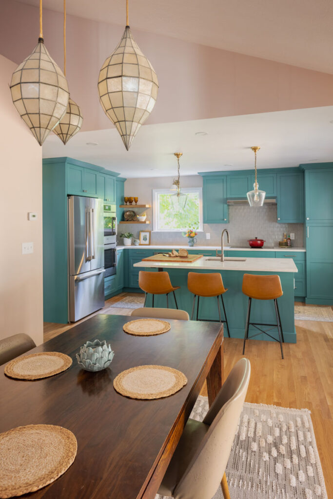 Melrose retro kitchen design with teal cabinetry, kitchen island, quartz countertops, and vintage Capiz shell pendant lights.