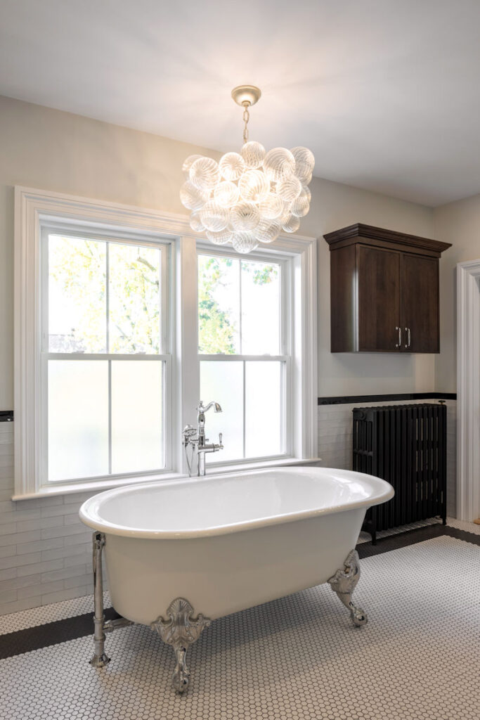 Bathroom remodel with clawfoot soaking tub and chandelier - McGuire + Co. Kitchen & Bath