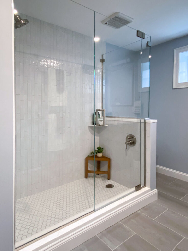 Basement bathroom remodel in Wakefield MA with custom shower with horizontal textured subway wall tile and hexagon shower floor tile