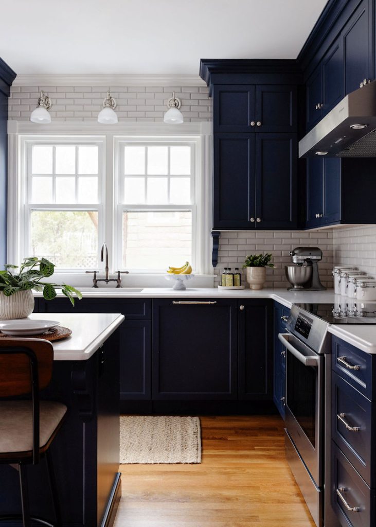 Wakefield victorian kitchen remodel design build project with navy blue cabinetry and white subway tile backsplash and wood flooring