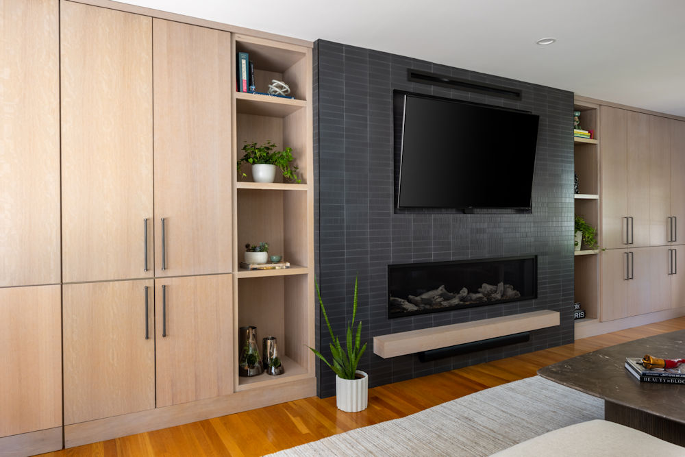 Lynnfield living room cabinetry with open shelving and black tile fireplace surround