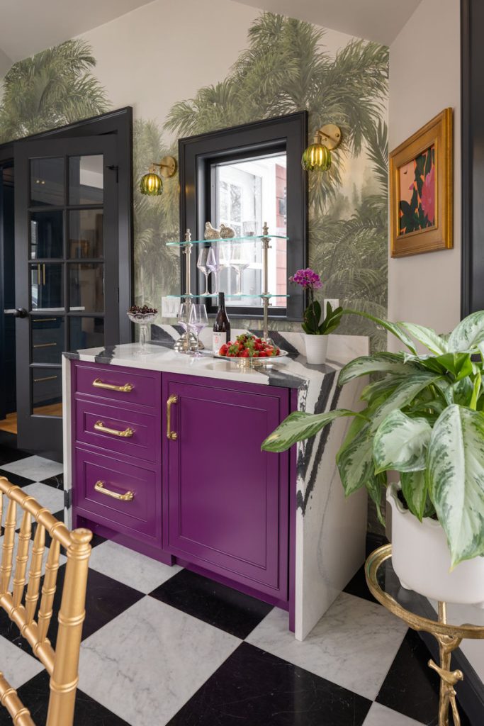 Melrose design-build project with salon breezeway raspberry cabinetry with bold black and white quartz countertop and palm tree wallpaper.