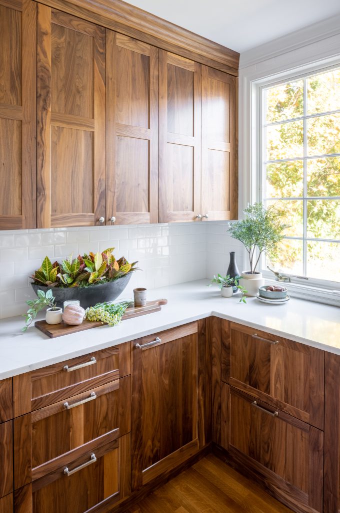 Kitchen design-build project with walnut cabinetry, quartz countertops and white subway tile backsplash.