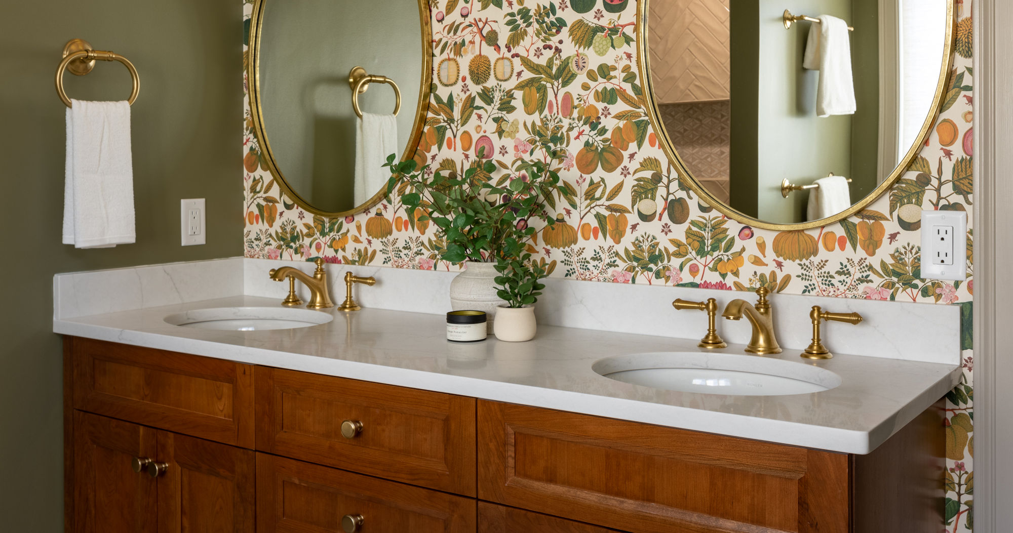 Winchester Primary Bathroom Remodel with cherry double-sink vanity, gold fixtures and hardware, and Mind the Gap Asians Fruits and Flowers green taupe pink wallpaper wall covering