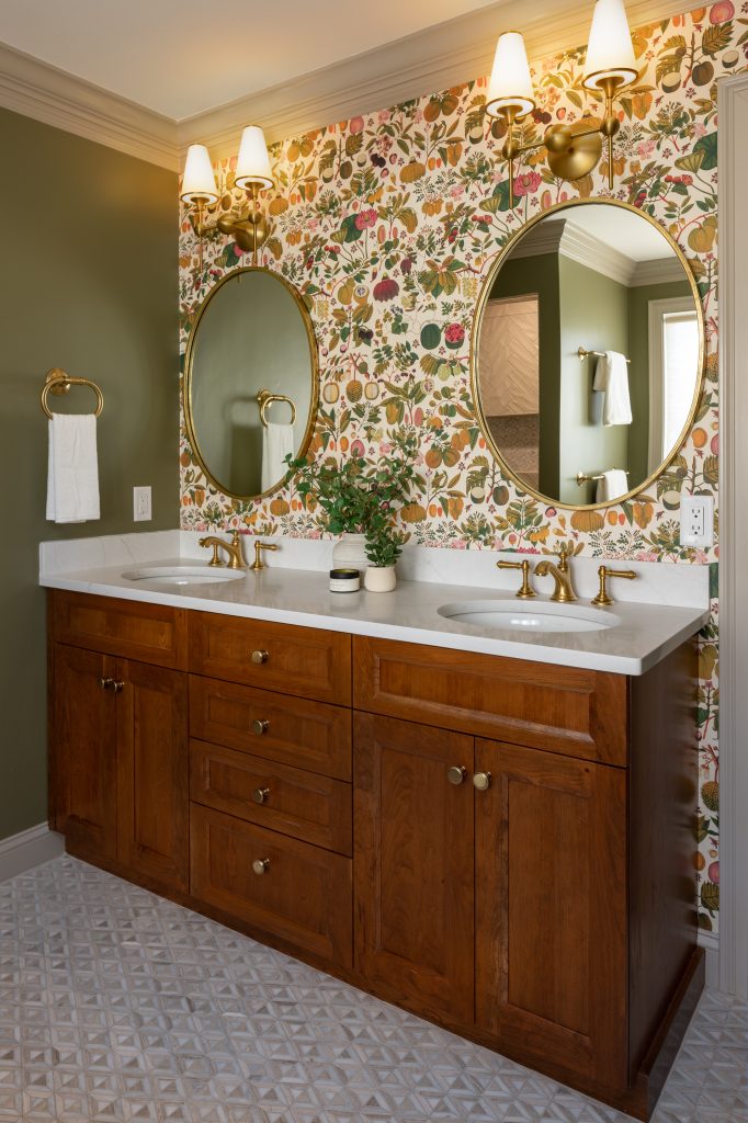 Winchester Primary Bathroom Remodel with cherry double-sink vanity, gold fixtures and hardware, and Mind the Gap Asians Fruits and Flowers green taupe pink wallpaper wall covering